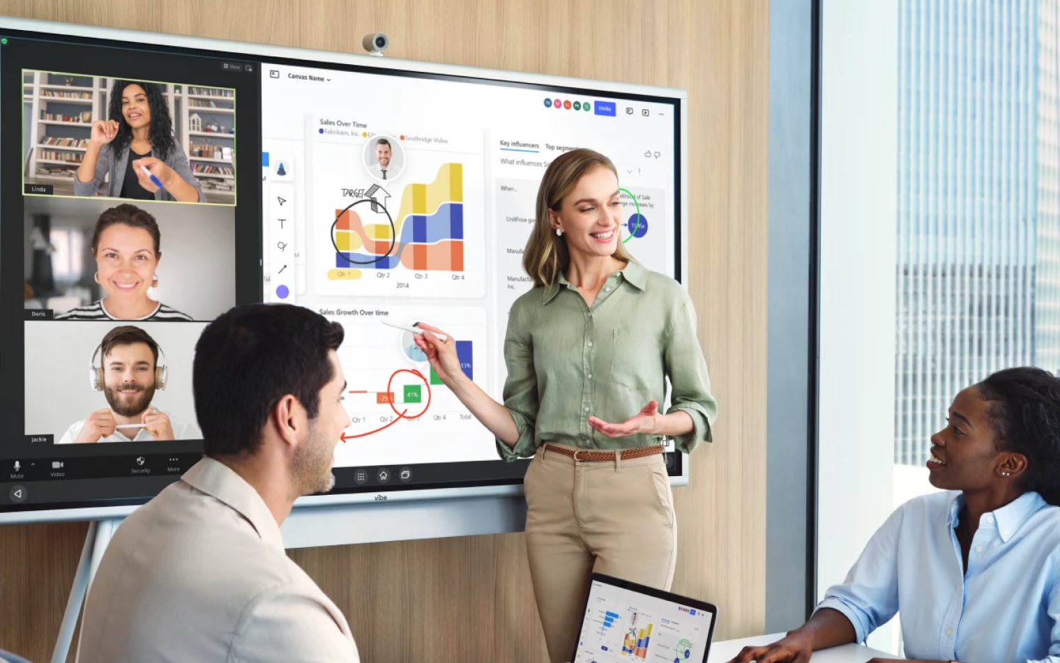 Diverse team aligning project ideas during hybrid in-person and virtual collaboration session.