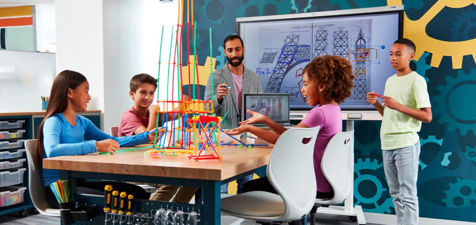 A classroom STEM project using a SMART Board, with students collaborating on interactive content during a guided lesson.